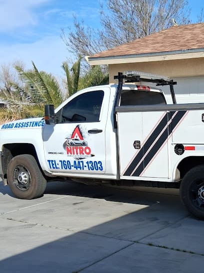 White Nitro Mobile Auto Mechanic road assistance truck with phone number 760-447-1303 on the door.